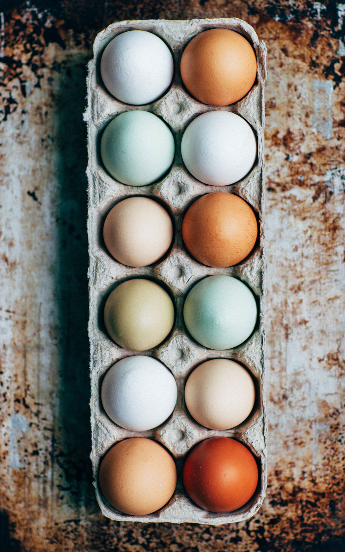 A carton of colorful farm eggs